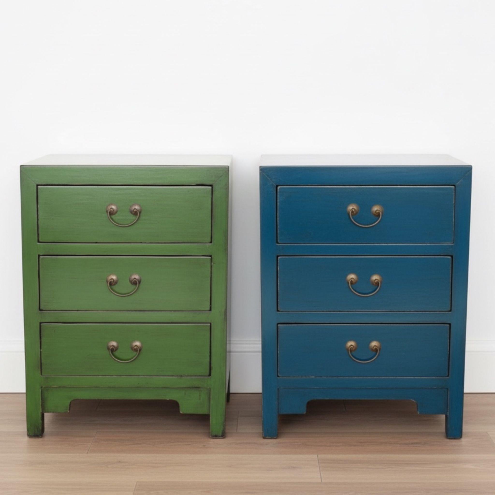 Green and blue Arka elmwood Bedside Tables styled in a minimalist studio with light wood floors and white walls