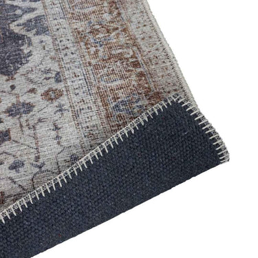 Close-up of a rug with a patterned corner on a white background