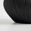 Black ribbed bowl base with textured surface and rounded shape.