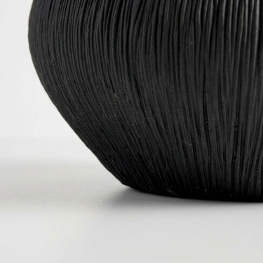 Black ribbed bowl base with textured surface and rounded shape.