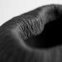 Atoll black ribbed bowl with textured surface and rounded shape.