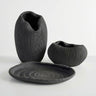 Atoll modern 3-piece set featuring a deep black ribbed vase, rounded bowl, and display oval tray.