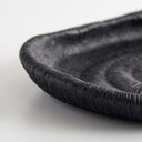 Deep black oval ribbed tray rim with a fine, textured surface and a raised rim.