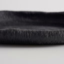 Deep black oval ribbed tray edge with a fine, textured surface and a raised rim.