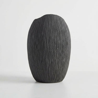 Deep black ribbed vase with fine ridges.