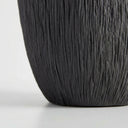 Deep black ribbed vase  base with fine ridges.