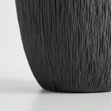 Deep black ribbed vase  base with fine ridges.