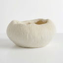Ribbed decorative bowl with a matte white finish and textured, wavy surface.
