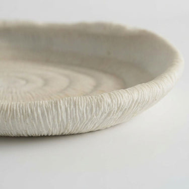 Atoll decorative tray raised rim with an off-white matte finish and ribbed, textured surface.