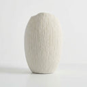 Ribbed vase back with a matte white finish and a textured surface.