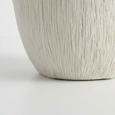 Ribbed vase base with a matte white finish and a textured surface.