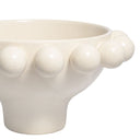 Close-up detail of the smooth matte glaze on a cream beaded footed bowl.