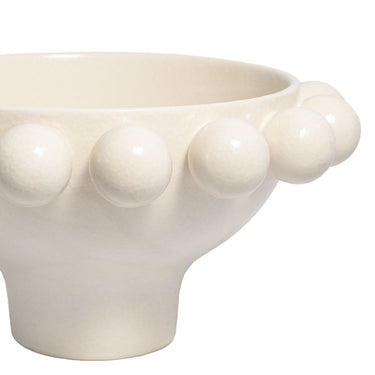 Close-up detail of the smooth matte glaze on a cream beaded footed bowl.