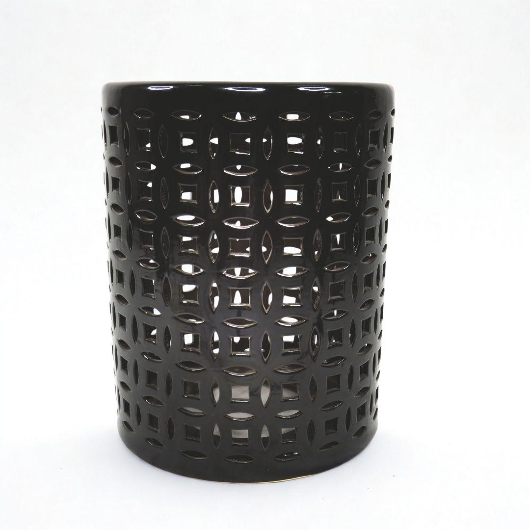 Round black ceramic stool styled as a side table
