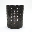 Round black ceramic stool styled as a side table