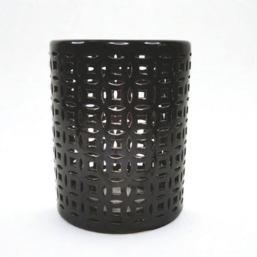 Round black ceramic stool styled as a side table
