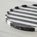 Close-up of black marble tray edge showing marble veining