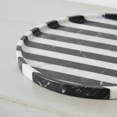 Close-up of black marble tray edge showing marble veining