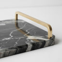 Close-up of the handle on a black marble tray