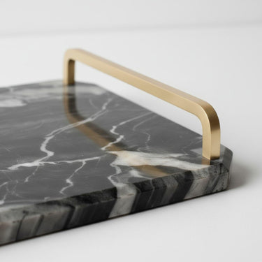 Close-up of the handle on a black marble tray