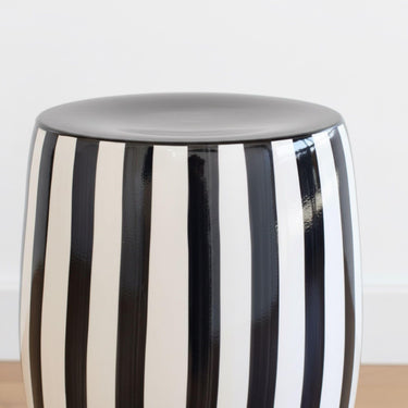 Detailed close-up of the crisp black-on-white striped pattern and high-gloss glaze of the Black striped side table.