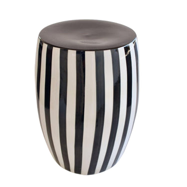 Angled view of the Black striped side table highlighting the smooth solid black circular top and rounded ceramic design.