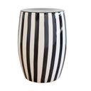 Black striped side table featuring a white ceramic base and bold vertical stripes for modern indoor-outdoor decor