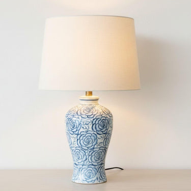 floral ceramic table lamp with linen shade switched on