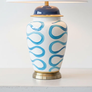 Detailed view of the unique hand-painted blue swirl design and elegant brass accent on the Blue Swirl Lamp