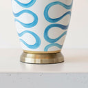 Close-up of the durable brushed brass pedestal base and high-quality ceramic construction of the Blue Swirl Lamp.