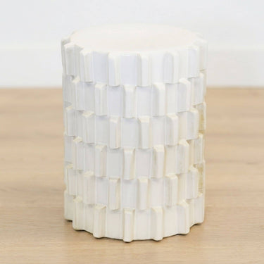 Off-white ceramic stool with natural tone variation on wooden floor