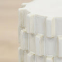 Close up of ceramic stool top edge showing natural tone variation in glazed block detail

