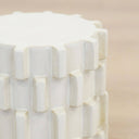 Close up of ceramic stool upper body showing offset block rows and flat top