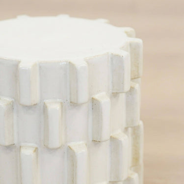 Close up of ceramic stool upper body showing offset block rows and flat top