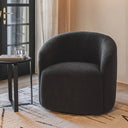 Camelot Swivel Chair in a modern living room, showing its compact size and rounded design.