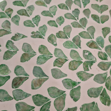 Green mosaic capiz shell stool close up