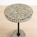 Round side table with a mother or pearl mosaic leaf pattern on the tabletop and matching circular base, supported by a black metal stand.
