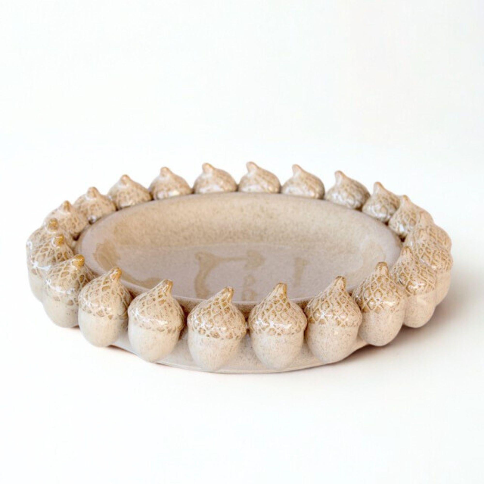 decorative ceramic bowl showing acorn detailing and smooth glaze.