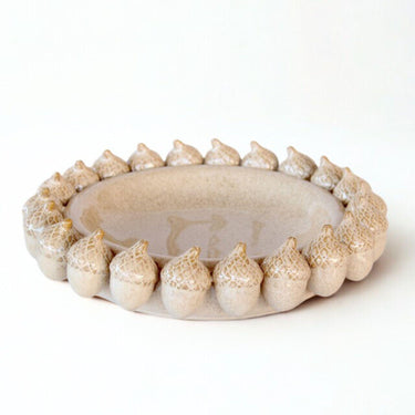 decorative ceramic bowl showing acorn detailing and smooth glaze.
