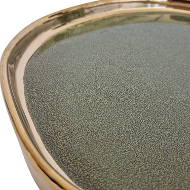 Close-up of ceramic tray showing green glaze and polished gold rim detail