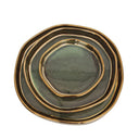 Top view of stacked ceramic tray set with organic shapes and gold rim