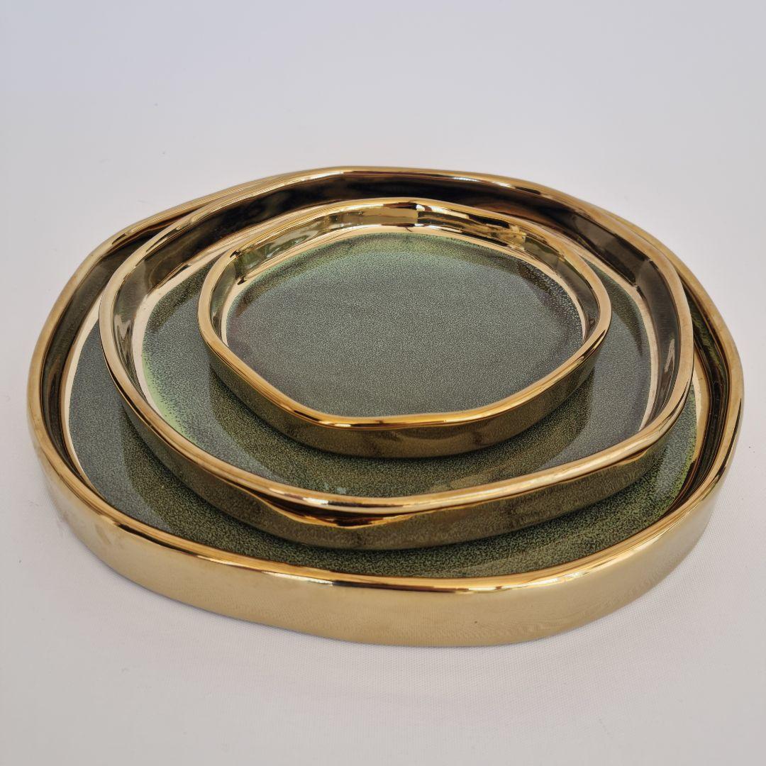 Ceramic decorative tray set styled and stacked at an angle on surface