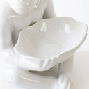 A glossy white ceramic bowl of a seated ceramic monkey lamp
