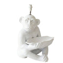 A white ceramic monkey lamp holding a leaf-shaped dish, with a chrome and white lamp socket at the top, shown against a plain white background.