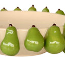 Green ceramic pears on a cream bowl