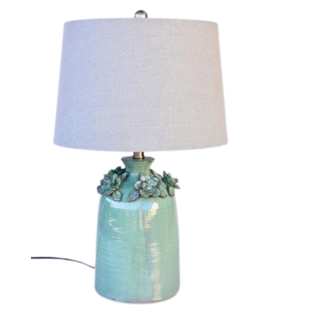 Bold ceramic table lamp with a minimalist design and flower details, an excellent choice for accenting your living room decor.