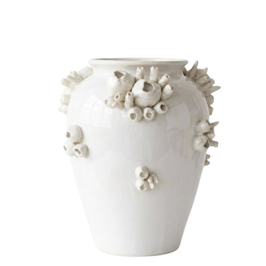 A glossy white ceramic vase decorated with raised organic coral-like sculptural details in off-white and light beige, shown against a plain white background.