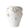 A glossy white ceramic vase decorated with raised organic coral-like sculptural details in off-white and light beige, shown against a plain white background.