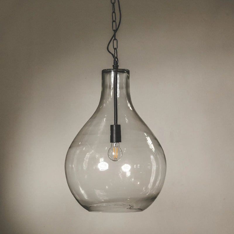Clear glass pendant light with a bulbous teardrop shape, suspended from a black metal chain with an exposed Edison-style light bulb inside.
