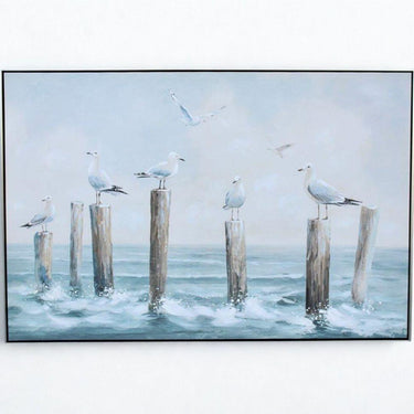 Framed canvas print of seaside scene with flying and perched seagulls